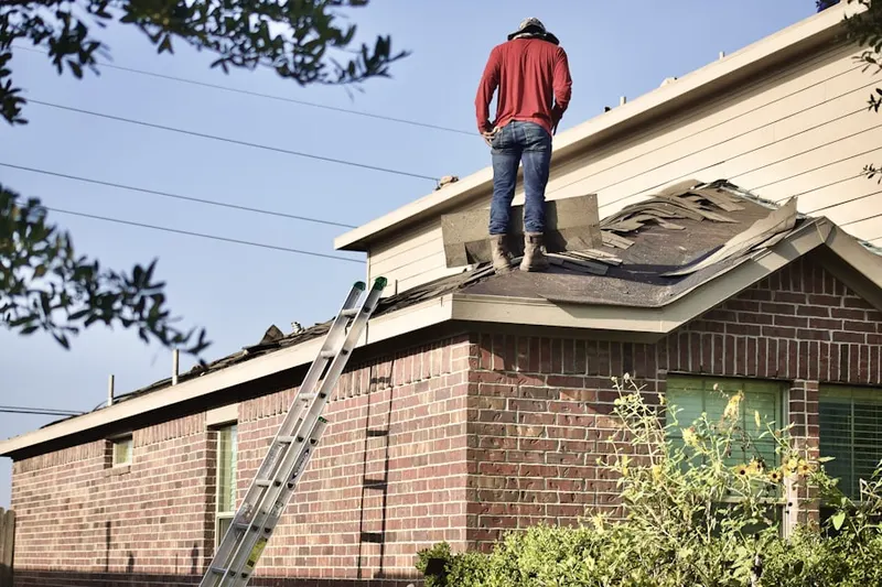 Professional roofer working on a residential roof in Marstons Mills